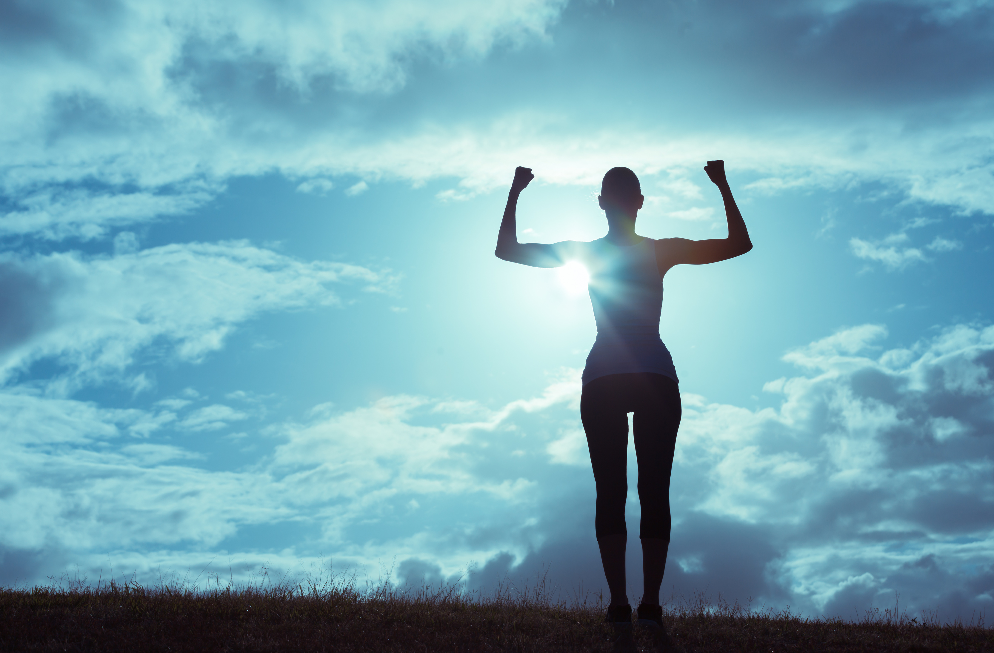 Strong woman flexing her muscles